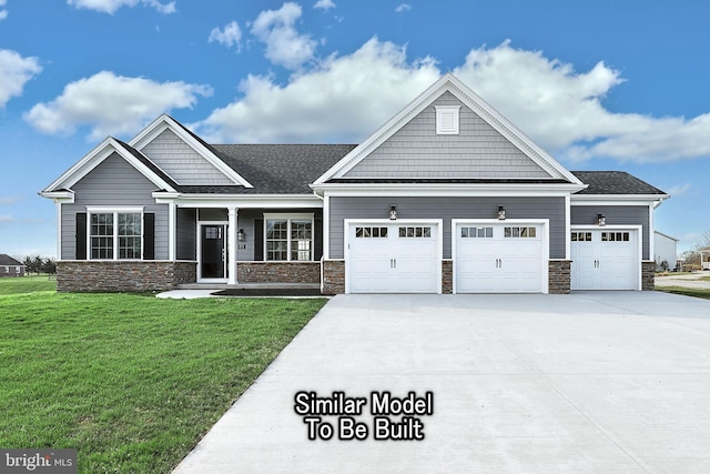 craftsman-style home featuring stone siding, concrete driveway, an attached garage, and a front yard