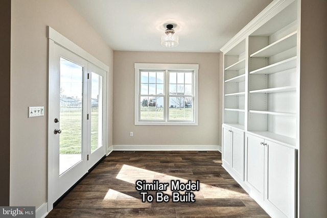 doorway to outside featuring a healthy amount of sunlight, dark wood-style floors, and baseboards