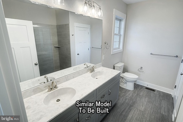 full bath featuring a sink, visible vents, and baseboards