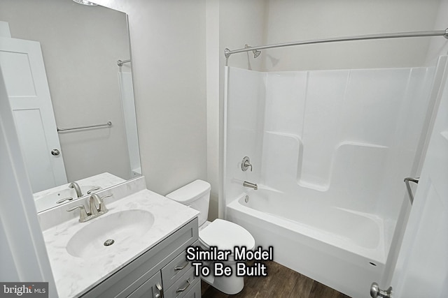 bathroom featuring toilet,  shower combination, wood finished floors, and vanity