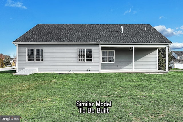 rear view of property featuring a lawn and roof with shingles