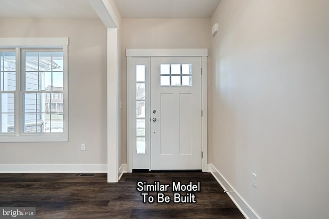 foyer entrance with dark wood-style flooring and baseboards