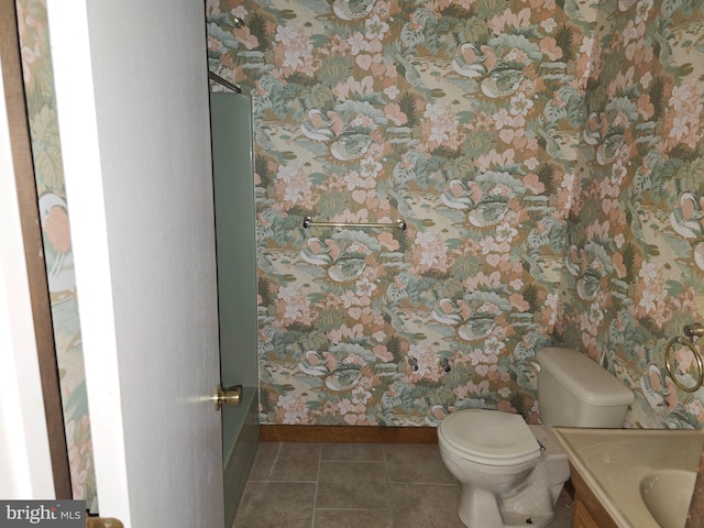 bathroom with wallpapered walls, baseboards, toilet, tile patterned floors, and vanity