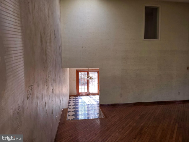 interior space featuring baseboards and wood finished floors