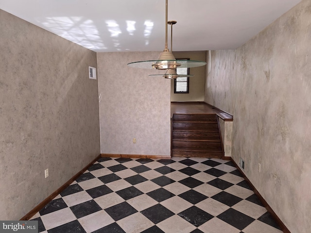 stairs featuring visible vents, baseboards, and tile patterned floors