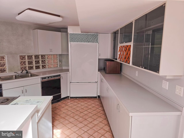 kitchen featuring paneled built in fridge, black dishwasher, white cabinets, light countertops, and a sink