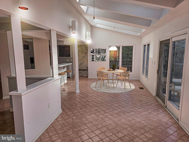 sunroom featuring vaulted ceiling with skylight and visible vents