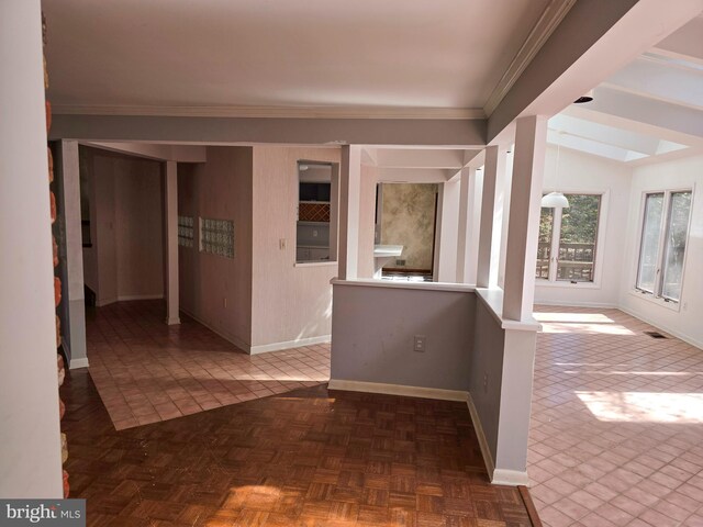 interior space with baseboards, vaulted ceiling, and crown molding