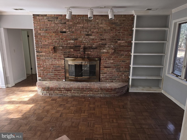 unfurnished living room with a brick fireplace, baseboards, visible vents, and ornamental molding