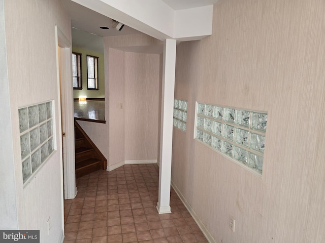 hall featuring dark tile patterned floors