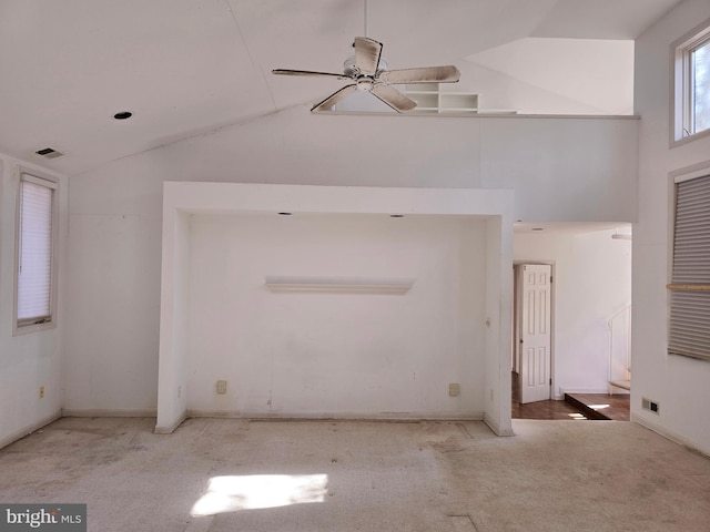 interior space featuring light carpet, high vaulted ceiling, visible vents, and a ceiling fan