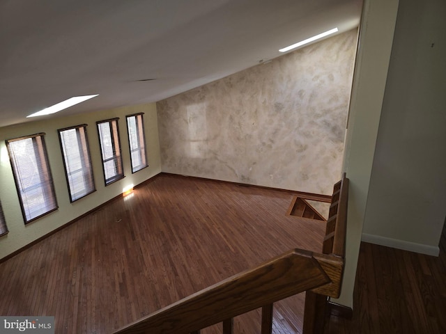 spare room with dark wood-style floors and baseboards