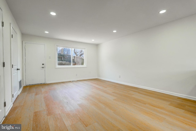 interior space with light wood-style flooring, visible vents, baseboards, and recessed lighting