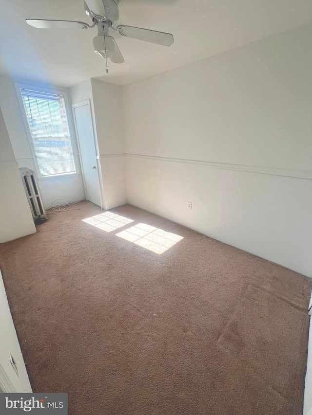 carpeted empty room with ceiling fan