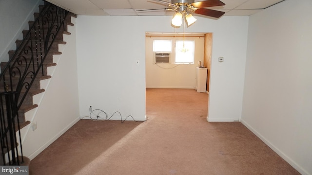 interior space with a paneled ceiling, baseboards, stairway, and carpet flooring
