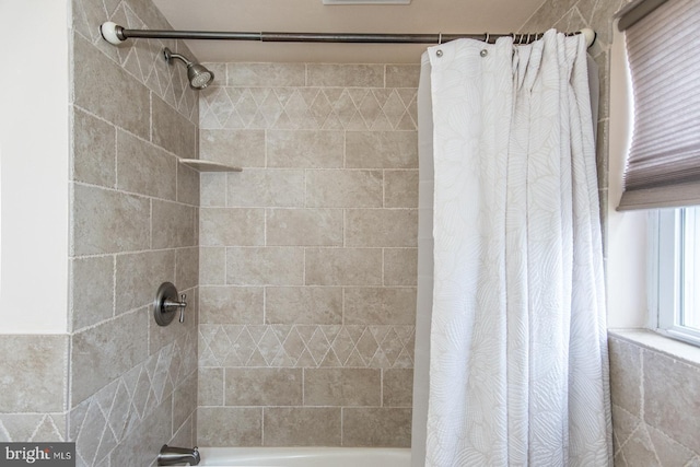 bathroom with shower / bath combo with shower curtain