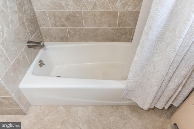 full bath featuring tile patterned flooring and shower / bathtub combination with curtain