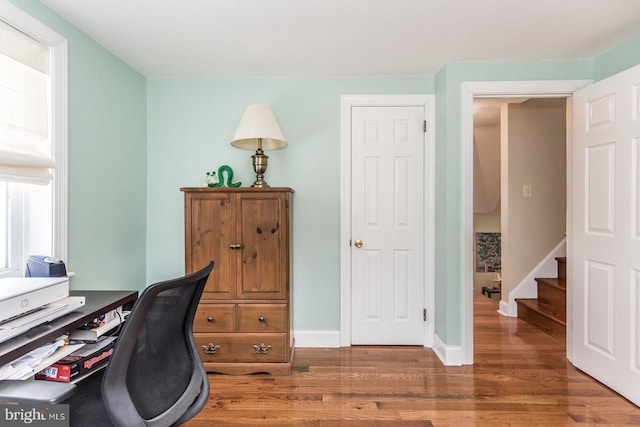 office featuring baseboards and wood finished floors