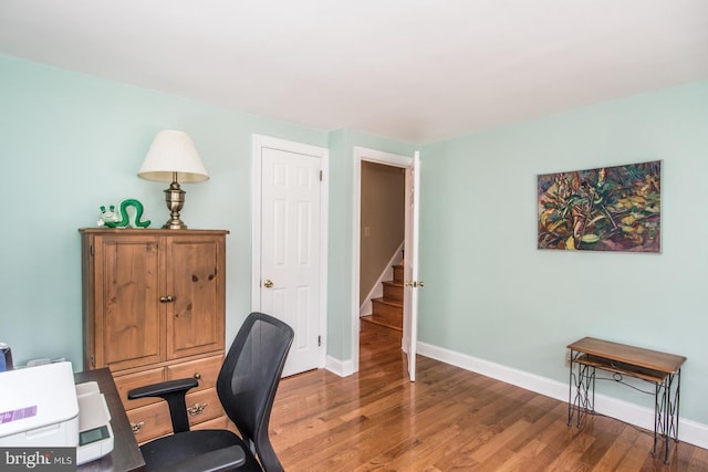 office with light wood-style flooring and baseboards