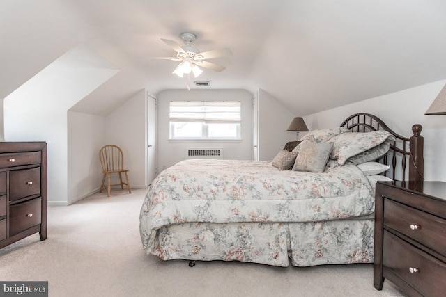 carpeted bedroom featuring a ceiling fan, lofted ceiling, radiator, and visible vents