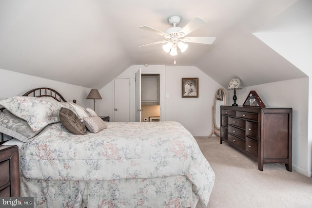 bedroom featuring vaulted ceiling, ceiling fan, and light colored carpet