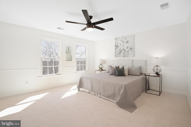 carpeted bedroom with visible vents and ceiling fan