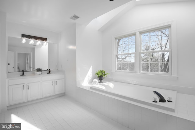 bathroom with tile patterned floors, visible vents, a sink, double vanity, and a bath