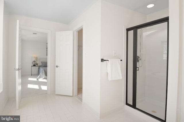 bathroom featuring tile patterned floors and a stall shower