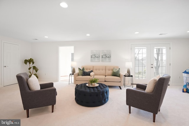 living room featuring recessed lighting, light colored carpet, baseboards, and french doors