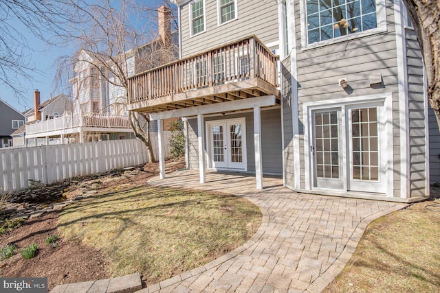 back of house featuring a patio area, french doors, a deck, and fence