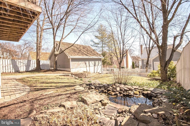 view of yard featuring an outbuilding and a fenced backyard