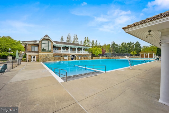 pool featuring a patio and fence