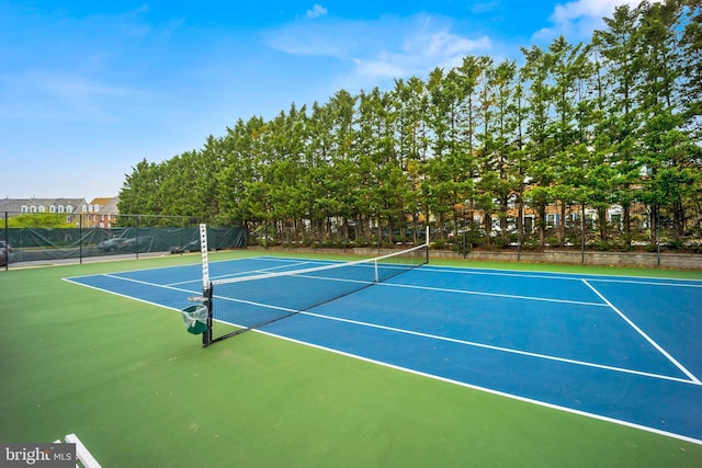 view of tennis court featuring fence