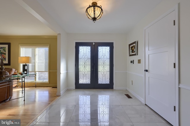 entryway with visible vents, baseboards, and french doors