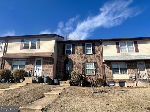 townhome / multi-family property with brick siding