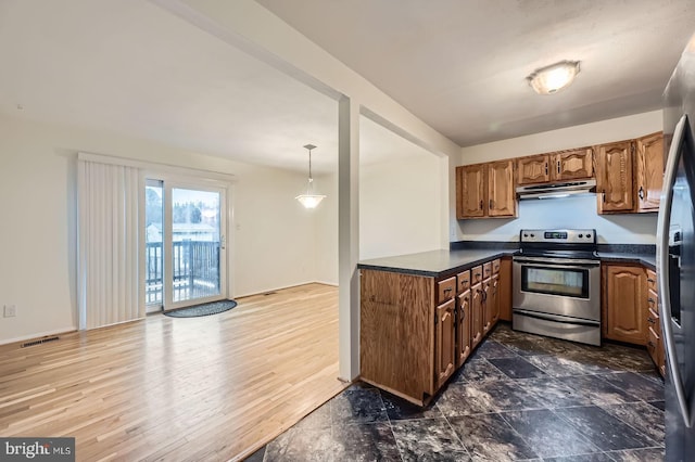 kitchen featuring dark countertops, under cabinet range hood, stainless steel electric range, and brown cabinetry