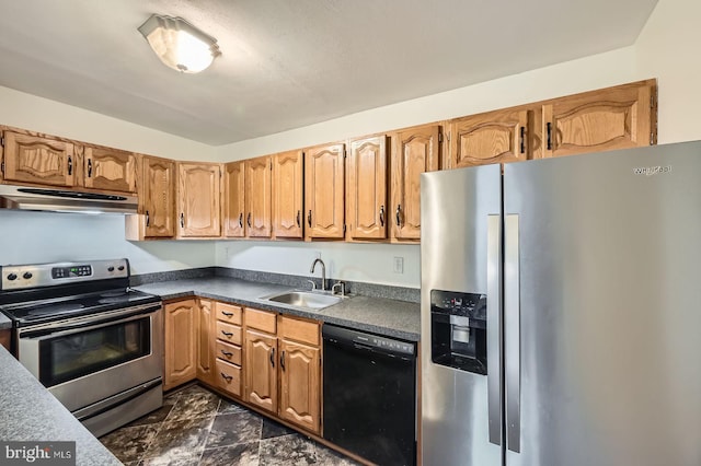 kitchen featuring dark countertops, under cabinet range hood, stainless steel appliances, and a sink