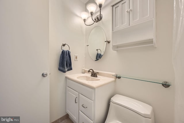 bathroom featuring toilet and vanity