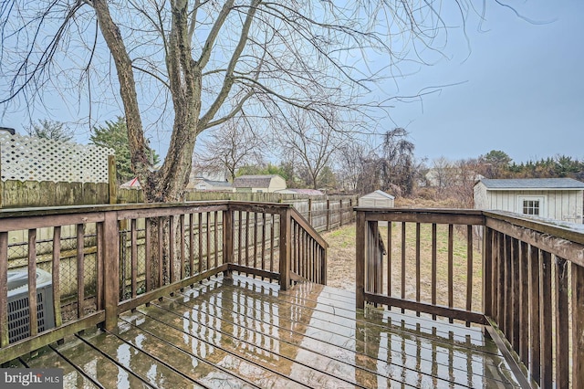 wooden terrace featuring a fenced backyard and an outdoor structure