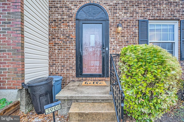 property entrance with brick siding