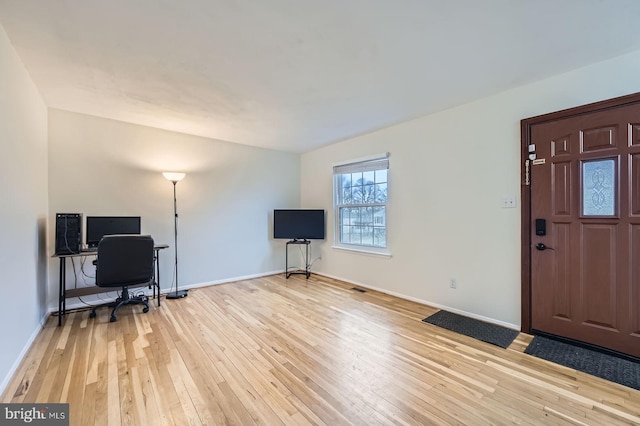 office featuring baseboards and light wood-style floors