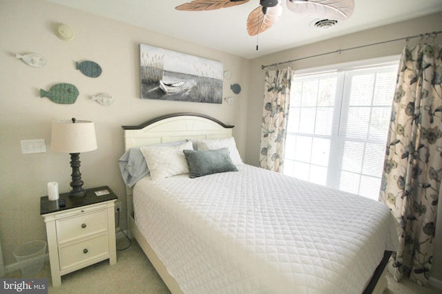 bedroom featuring light colored carpet, ceiling fan, and visible vents