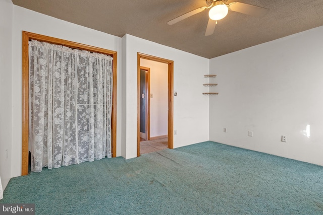 unfurnished room with carpet, a ceiling fan, and a textured ceiling