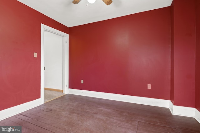 empty room featuring ceiling fan, hardwood / wood-style floors, and baseboards