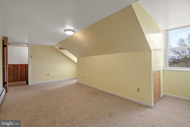 bonus room featuring light carpet, vaulted ceiling, and baseboards