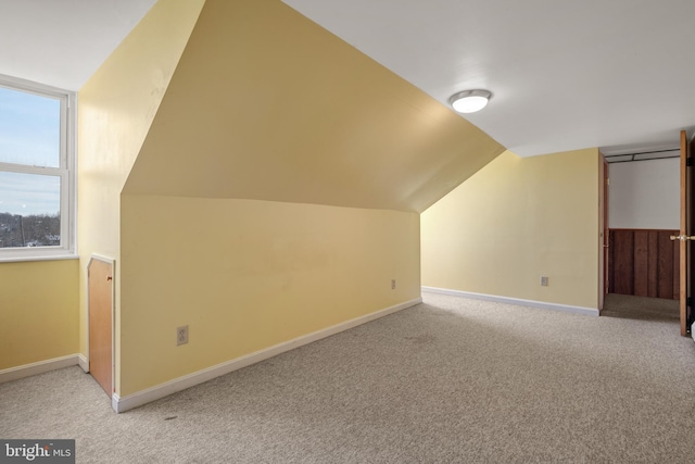 bonus room with lofted ceiling, carpet, and baseboards