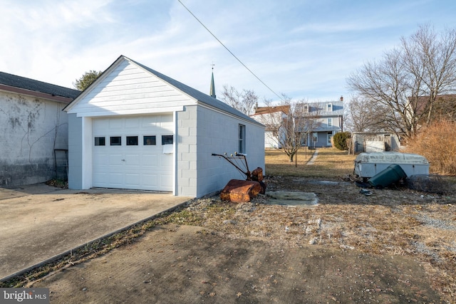 detached garage with concrete driveway