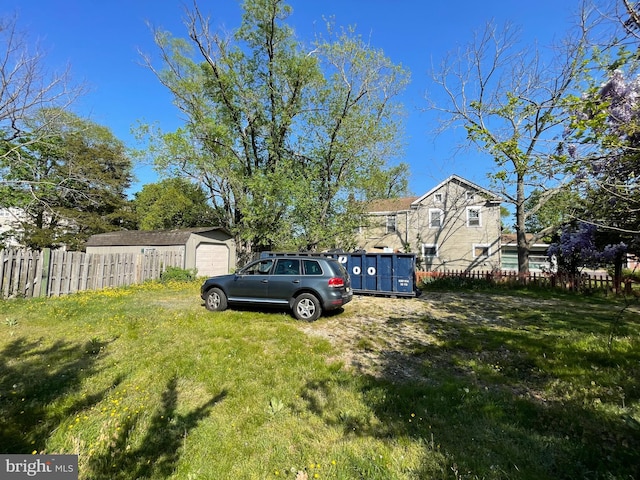 view of yard with a garage and fence