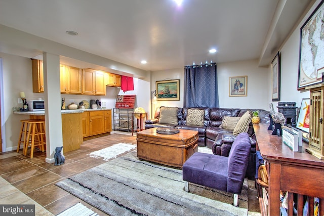 tiled living area with recessed lighting and baseboards