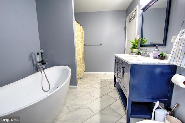 full bath featuring a freestanding bath, marble finish floor, vanity, and baseboards